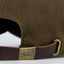 Brass clasp of the Brown Waxed Canvas Hat by DECOY featuring  leather strap, and brass clasp for classic waterfowl hunting style, rear view
