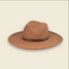 A classic wide-brim fedora hat in a warm camel brown color, featuring a dark brown leather band around the crown, set against a solid cream background.