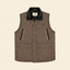 A brown diamond-quilted utility vest with a black fleece collar, featuring snap-button front closure, zippered chest pockets, and flap pockets on the lower front, shown against a solid cream background.