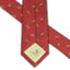 Close-up of pheasant silk tie tip featuring DECOY logo and detailed stitching